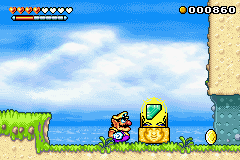 Wario with an open jewel piece box and a Gold Coin in the Palm Tree Paradise level.