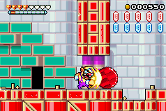 Wario ramming a round red rock in Toy Block Tower