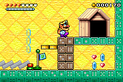 Screenshot of Wario who is too late to reach a button, leaving the domino blocks intact. From Wario Land 4.