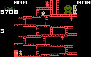 A screenshot from the Intellevision port of Donkey Kong is shown. The graphics are crude, with a simple color palette and characters like Donkey Kong, Mario, and Pauline being represented by abstract blocky shapes.
