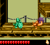 Dixie Kong throws a Steel Barrel at the Koin of Total Rekoil in Donkey Kong GB: Dinky Kong & Dixie Kong