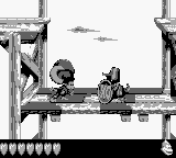 Dixie Kong holding a Steel Barrel at a Koin in Ford Knocks in the original Game Boy release of Donkey Kong Land III