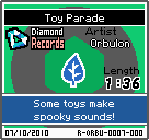 The shelf sprite of one of Orbulon's records (Toy Parade) in the game WarioWare: D.I.Y., as it appears on the top screen.