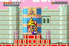 Wario holding a triangle block in Toy Block Tower