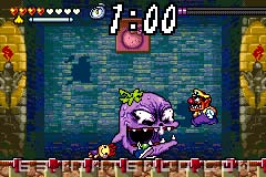 The fight against Spoiled Rotten in a pre-release version of Wario Land 4. The TV set with the two Nintendo GameCubes and the kitchen equipment in the background are not seen.