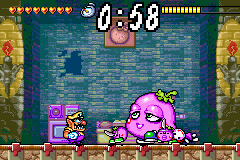 Screenshot of Wario battling Spoiled Rotten, who is accompanied by two Eggplant Warriors
