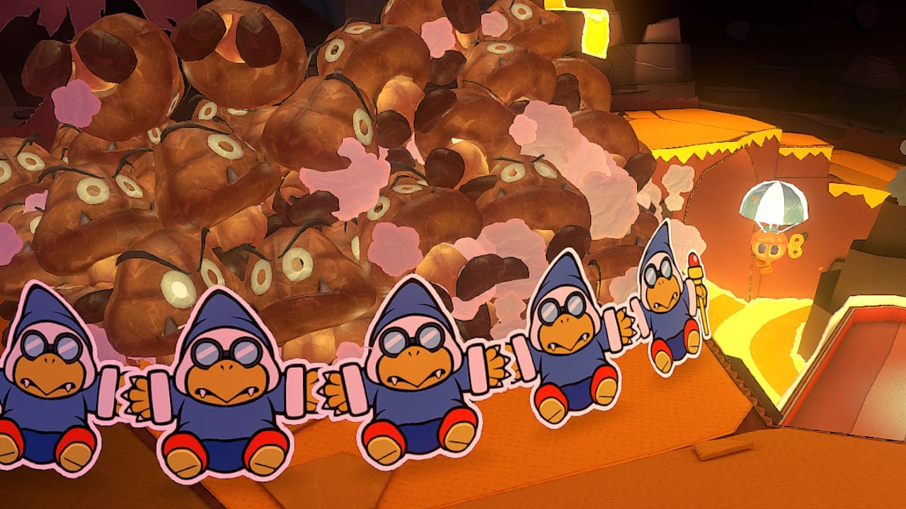 Kamek using magic to hold back the Paper Macho Goombas