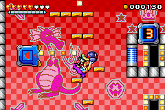 Wario about to throw a Chomp ball into a pinball tulip, with a pinball digital counter behind him.