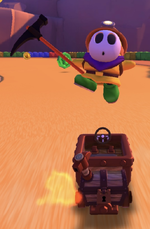Yellow Shy Guy (Explorer) performing a trick.