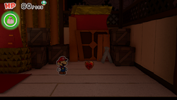 Mario standing near a Healing Heart in Big Sho' Theater of The Origami King.