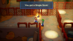 Mario finding a Single Sock in Mario & Luigi: Brothership.