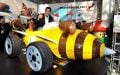 Reggie in a life-sized replica of the Bumble V kart from Mario Kart 7, at the 2011 LA Auto Show
