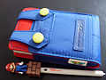 A Nintendo DS case designed after Mario's shirt and overalls. Comes with a long stylus of Mario standing on top of a Brick Block Manufactured by PDP (Performance Designed Products)