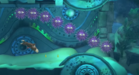 Donkey Kong swimming beneath a group of Sea Urchins in Donkey Kong Country: Tropical Freeze