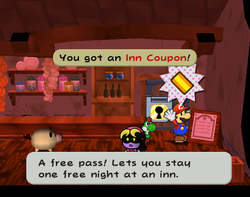 Mario getting the Inn Coupon from behind a sign in Twilight Town of Paper Mario: The Thousand-Year Door.