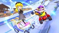 Peach (Wintertime) and Wario (Hiker) tricking on Wii DK Summit, with Penguin Toad in the distance approaching a half-pipe