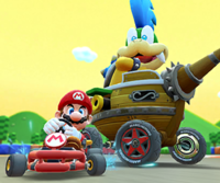 Thumbnail of the Baby Luigi Cup challenge from the 2023 Mario vs. Luigi Tour; a vs. Mega Larry challenge set on SNES Mario Circuit 2