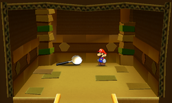Mario near the Magnifying Glass Thing in Sandshifter Ruins of Paper Mario: Sticker Star.