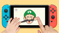 Luigi's moustache and ear being pulled on a Nintendo Switch