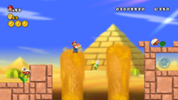 A screenshot of Mario carrying a Red Shell through World 2-1 in New Super Mario Bros. Wii.
