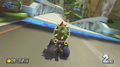 Bowser near the new anti-gravity Boost Pad (blue, with circles) in Mario Circuit from Mario Kart 8.