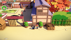 Mario standing near a flower pot containing a Mushroom in Shogun Studios of The Origami King.