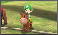 Baby Luigi, riding a horse from Mario Sports Superstars.