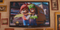 The Super Mario Bros. Plumbing commercial shown on a television at Punch-Out Pizzeria