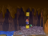 Mario next to the Shine Sprite in the floating barrel room