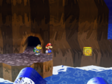 Mario next to the Shine Sprite above water in the Pirate's Grotto