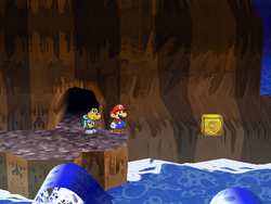 Mario next to the Shine Sprite above water in the Pirate's Grotto in Paper Mario: The Thousand-Year Door.