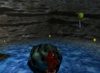 A set of yellow Banana Coins and a yellow Banana Balloon in Crystal Caves.