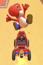 Red Yoshi performing a trick.