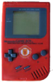 A red "Play It Loud!" Game Boy with the Manchester United logo at the center