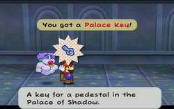 Screenshot of Mario obtaining a Palace Key in the Palace of Shadow's Riddle Tower.