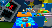 Mario near a stone wheel in the Toy Time Galaxy
