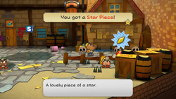 Mario collecting the Star Piece behind a crate in the east of Rogueport Square, from the remake of the Paper Mario: The Thousand-Year Door for the Nintendo Switch.