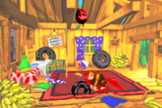 Photograph #1g Hidden behind a large bunch of bananas on the left side of DK's Tree House. The photograph shows Donkey Kong and Diddy Kong swinging from vines, an artwork used for the original version's title screen, and appears on the 11th page of the Scrapbook.