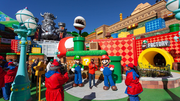 People posing with Mario and Luigi at Super Nintendo World in Universal Studios Hollywood