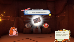 Mario being given the Silver Membership Card by the item shop shopkeeper in Breezy Tunnel of The Origami King.