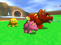 Tricky and two smaller triceratops in the ending for Diddy Kong Racing. Pipsy is riding on the pink one.