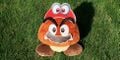 Photo of a Goomba plush toy wearing Cappy and mustache cut-outs from a printable from Play Nintendo