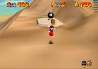 This image shows an example of HOLP manipulation in Super Mario 64. I pre-set the HOLP at the location the Bob-omb is visible on the screenshot by grabbing a Bob-omb and letting go of it after reaching this spot. Then, I got the Hat-in-Hand glitch, which allows me to grab and throw objects without updating the HOLP. With the hat in my hand, I grabbed another Bob-omb and threw it, so that it spawned at the pre-set HOLP, facing in Mario's direction. This is  visible on the screenshot.