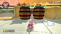 Screenshots of several racetracks from Mario Kart games, taken in places with barrels.