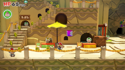 Mario standing near 14 10-Coins in Picnic Road of The Origami King.