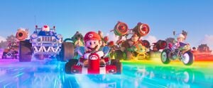 Mario and many other characters driving on a rainbow road