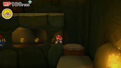 Mario standing near 4 Coins in Sea Tower of The Origami King.