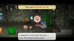 Mario getting the Silver Card from Pine T. Jr. in Rogueport Underground of Paper Mario: The Thousand-Year Door for Nintendo Switch.