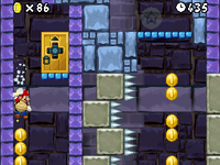 Mario sliding down a wall collecting Coins in World 1-Tower.