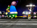 Wario (the winner of the board) shoots Bowser from behind.